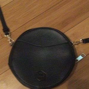 NWOT. Black circle genuine leather crossbody belt bag. 23” round x 7.5” width.